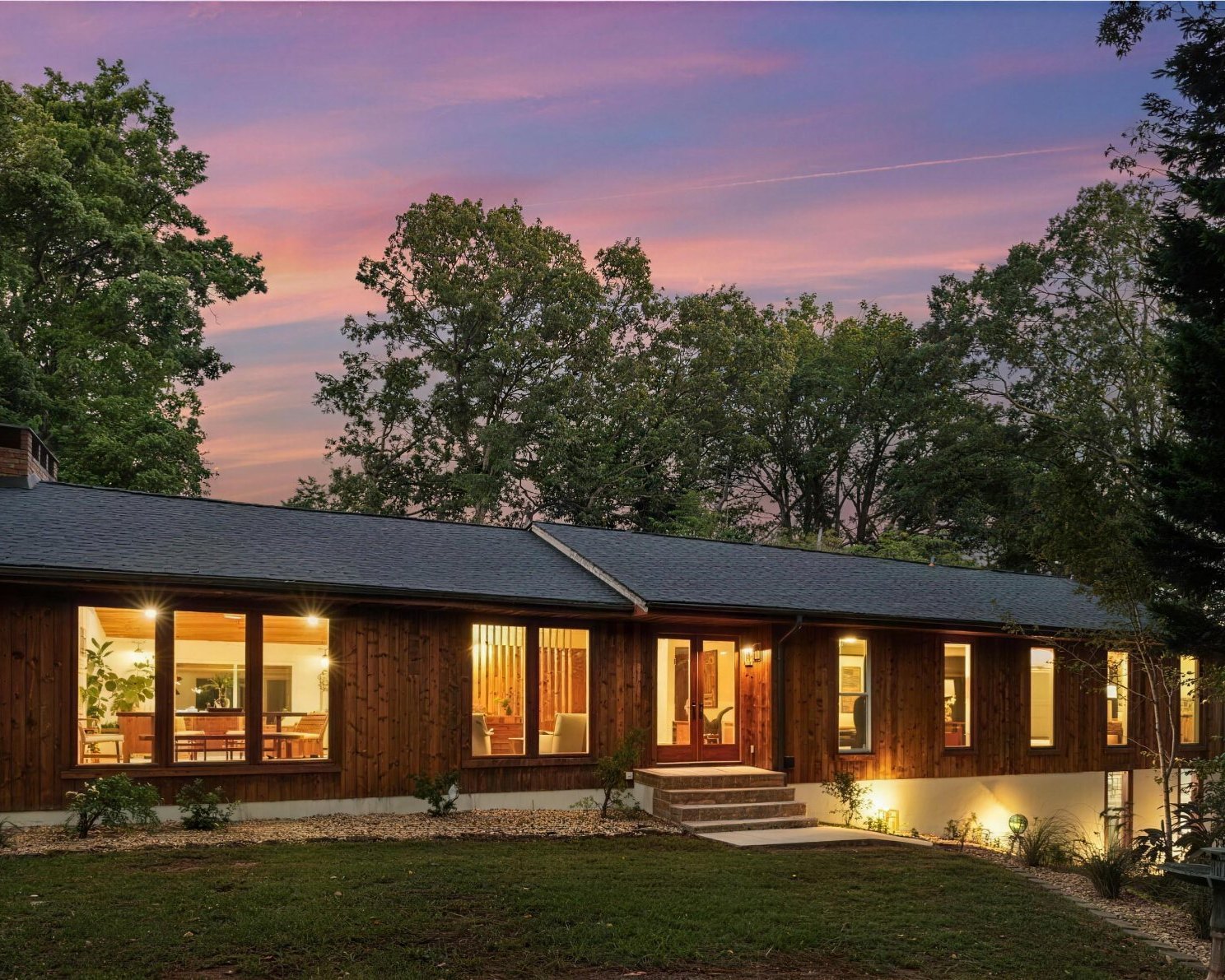 A completed Balinese-inspired mid-century renovation in Smyrna at dusk